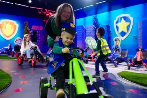 Child riding a cart at the PAW Patrol™ Experience: Only at CAMP
